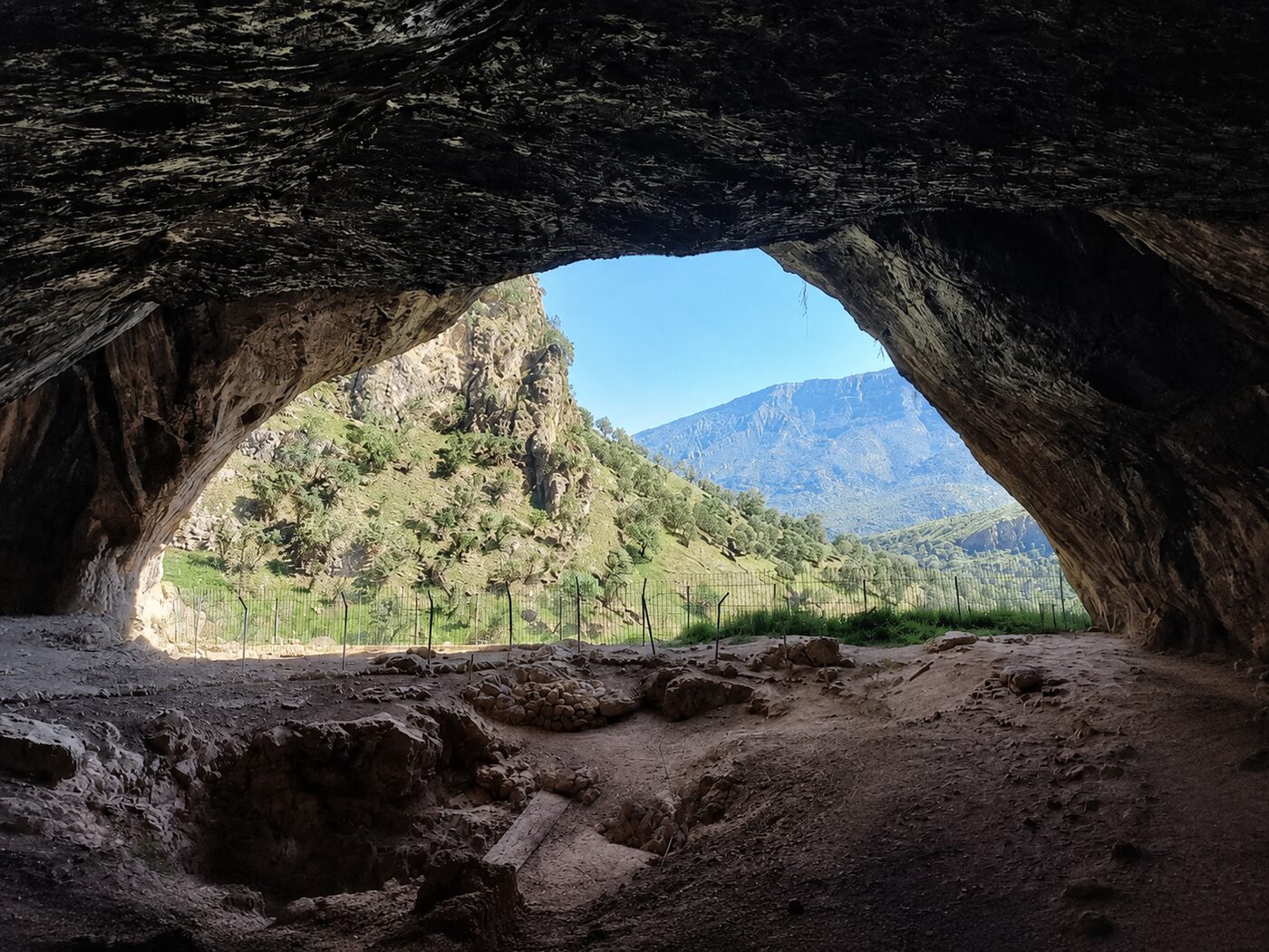 The view from inside Shanidar Cave looking out across the green Bradost mountains and valley in the Kurdistan Region of Iraq