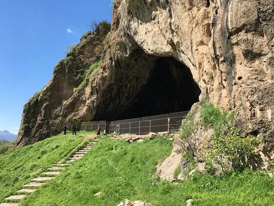 The large mouth of Shanidar Cave in a limestone mountainside in the Kurdistan Region of Iraq