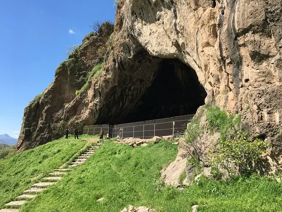 The large mouth of Shanidar Cave in a limestone mountainside in the Kurdistan Region of Iraq